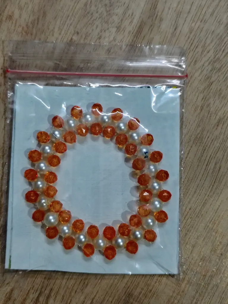 Orange and white pearl braided bracelet