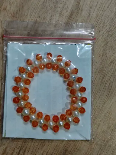 Orange and white pearl braided bracelet