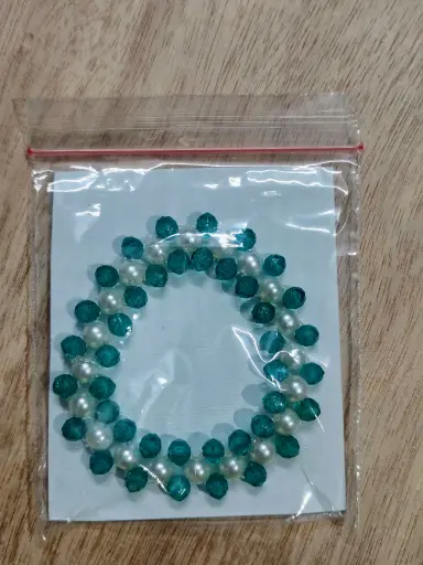 Green and white pearl braided bracelet